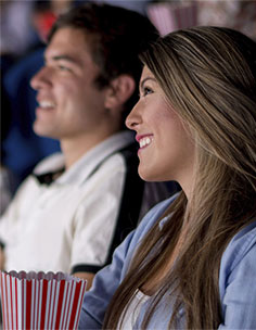 Woman Eating Popcorn in the Movie Theater at Jersey City Apartment Rentals